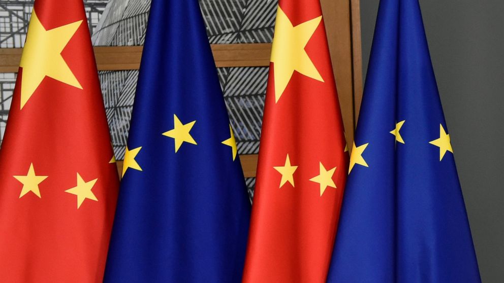 FILE - In this file photo dated Tuesday, Dec. 17, 2019, EU and Chinese flags at the Europa building in Brussels. China’s European Union envoy on Wednesday Jan. 27, 2021, is urging the 27-nation European bloc to deepen its ties with his country even f
