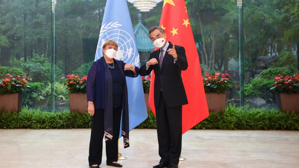 In this photo released by Xinhua News Agency, Chinese Foreign Minister Wang Yi, right, meets with the United Nations High Commissioner for Human Rights Michelle Bachelet in Guangzhou, southern China's Guangdong Province on Monday, May 23, 2022. (Deng