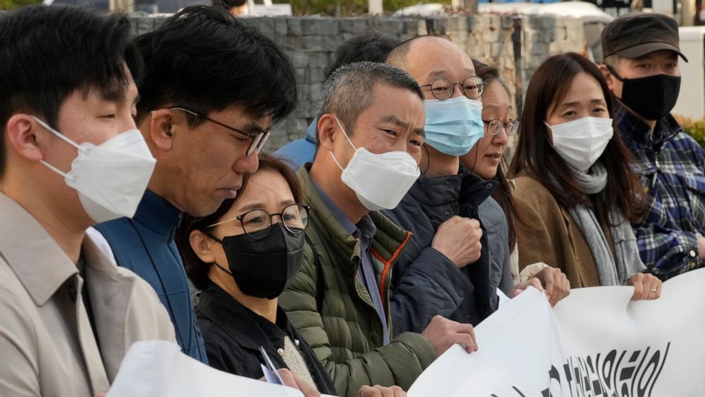 Peter Møller, fourth from left, attorney and co-founder of the Danish Korean Rights Group, attends a press conference with a group of South Korean adoptees in front of the Truth and Reconciliation Commission in Seoul, South Korea, Tuesday, Nov. 15, 2