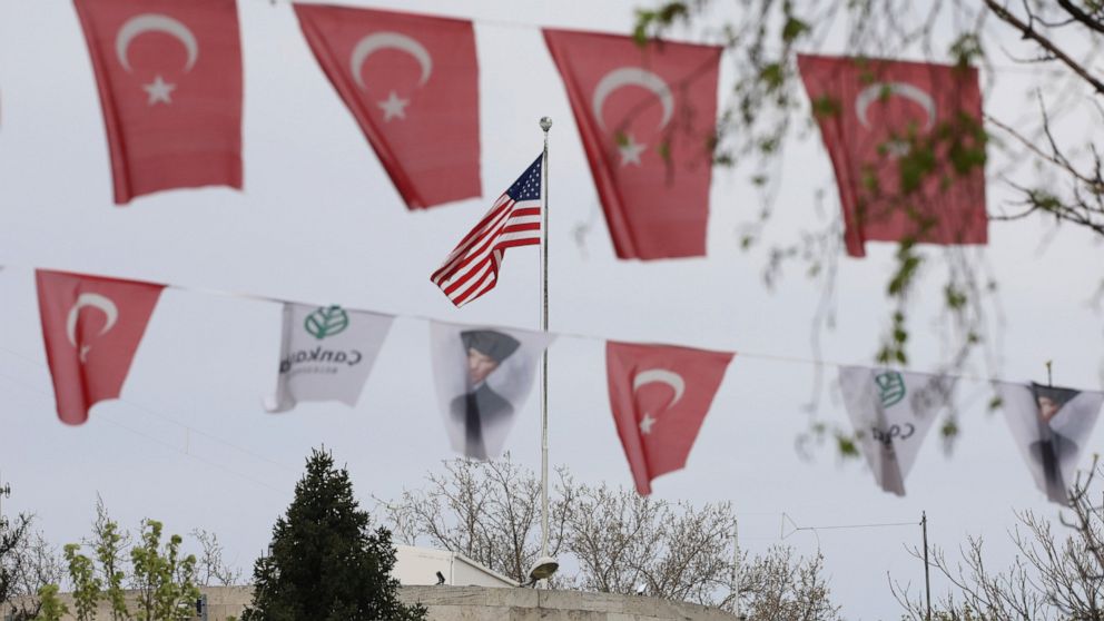 Turkish flags and banners depicting Mustafa Kemal Ataturk, the founder of modern Turkey, decorate a street outside the United States embassy in Ankara, Turkey, Sunday, April 25, 2021. Turkey's foreign ministry has summoned the U.S. Ambassador in Anka