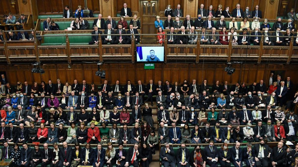 In this photo provided by UK Parliament, Ukrainian President Volodymyr Zelenskyy is displayed on the screen as he addresses British lawmakers in the House of Commons in London, Thursday March 8, 2022. Speaking by video link, the Ukrainian leader urge