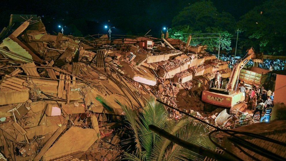 Rescue workers look for survivors after a residential building collapsed in Mahad, about 170 kilometers (105 miles) from India's financial capital of Mumbai, Monday, Aug. 24, 2020. Many people feared injured and more than 65 were trapped inside after