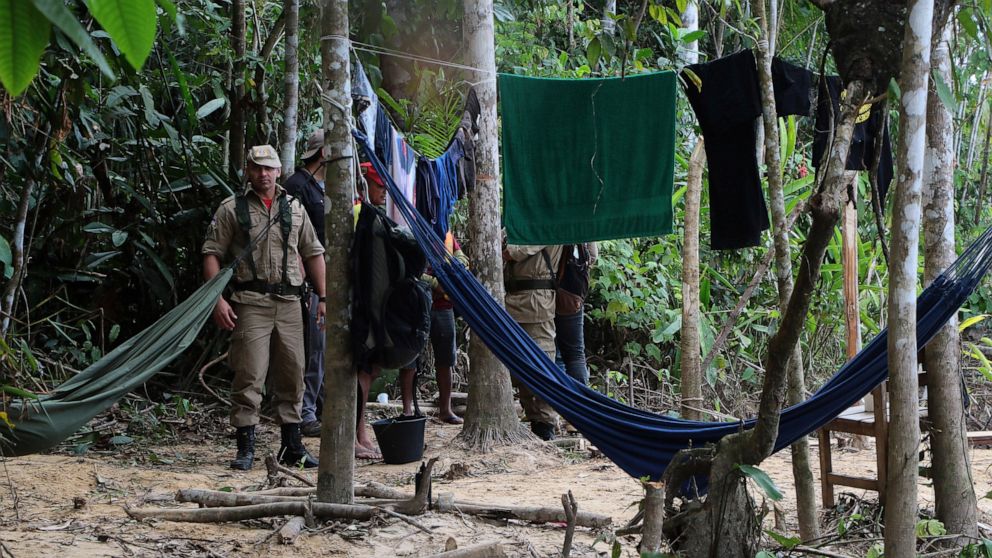 Firefighters arrive at a camp set up by Indigenous people to search for Indigenous expert Bruno Pereira and freelance British journalist Dom Phillips in Atalaia do Norte, Amazonas state, Brazil, Tuesday, June 14, 2022. The search for Pereira and Phil