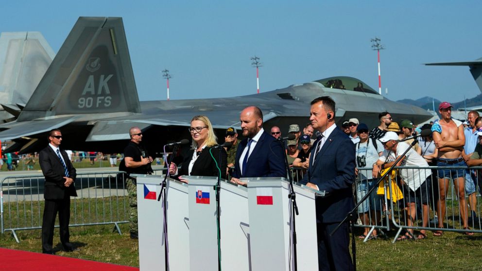 From right, Defense Ministers of Poland Mariusz Blaszczak, of Slovakia Jaroslav Nad and of Czech Republic Jana Cernochova answer questions to media after signing an air policing treaty at an airshow in Malacky, Slovakia, Saturday, Aug. 27, 2022. Pola