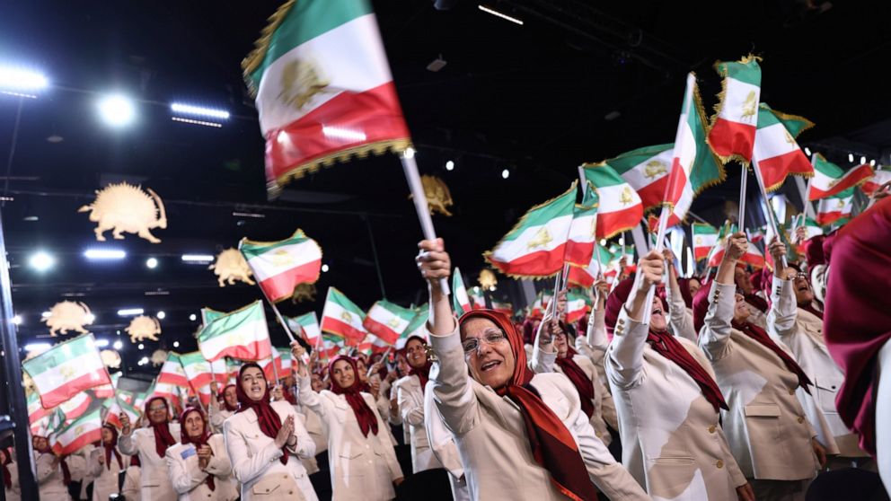 Members of the Ashraf-3 camp wave Iranian flags during the speech of former U.S. Vice President Mike Pence at the Iranian opposition headquarters in Albania, where up to 3,000 MEK members reside at Ashraf-3 camp in Manza town, about 30 kilometers (16