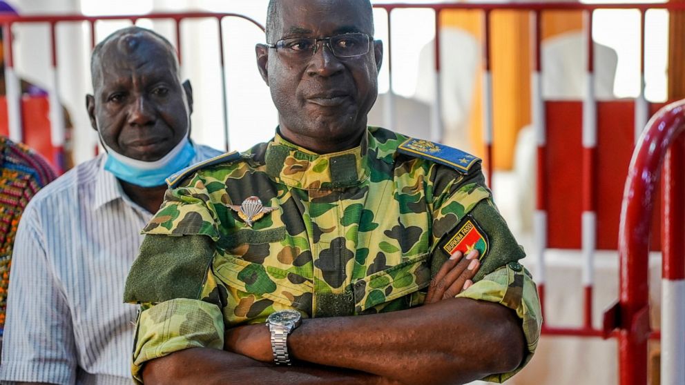 Burkina Faso General Gilbert Diendere sits in a military court where he stands trial with 13 others, including former President Blaise Compaore, charged with the murder of leader Thomas Sankara, in Ougadougou, Burkina Faso, Monday, Oct. 11, 2021. A m