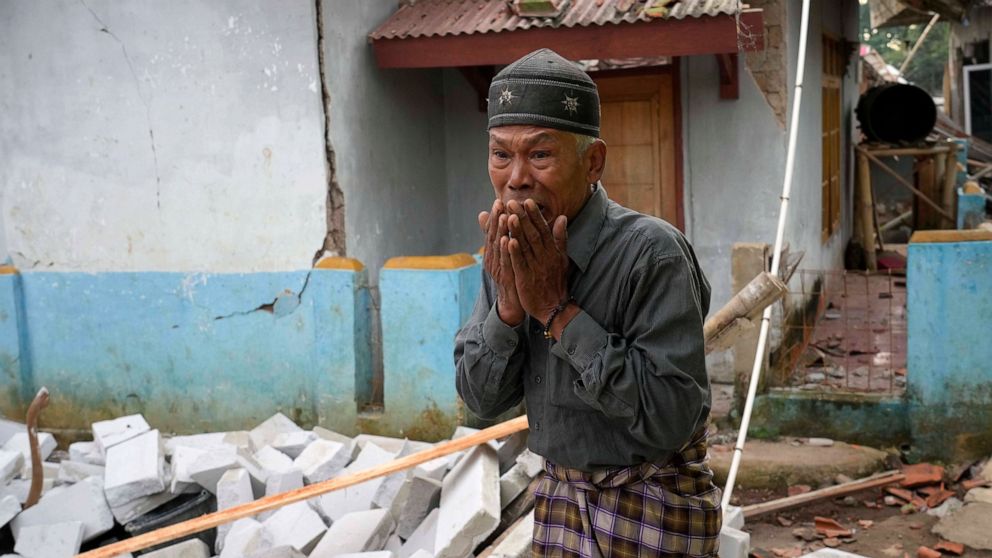 A man reacts as he inspects the damage caused by Monday's earthquake in Cianjur, West Java, Indonesia Tuesday, Nov. 22, 2022. The earthquake has toppled buildings on Indonesia's densely populated main island, killing a number of people and injuring h