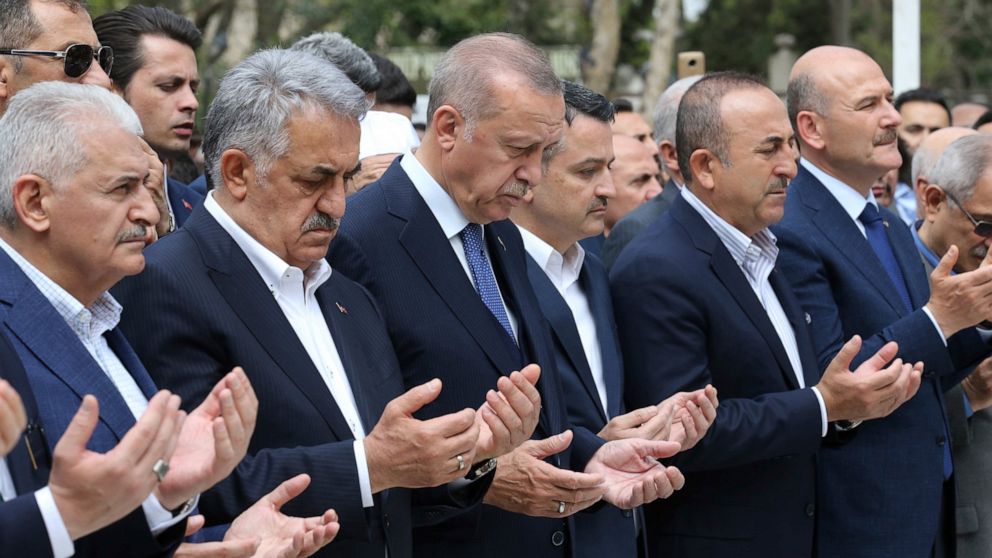 Turkey's President Recep Tayyip Erdogan, third left, his party's mayoral candidate for Istanbul Binali Yildirim, left, his ministers Bekir Pakdemirli, third right, Mevlut Cavusoglu, second right, and Suleyman Soylu, right, atttend funeral prayers for