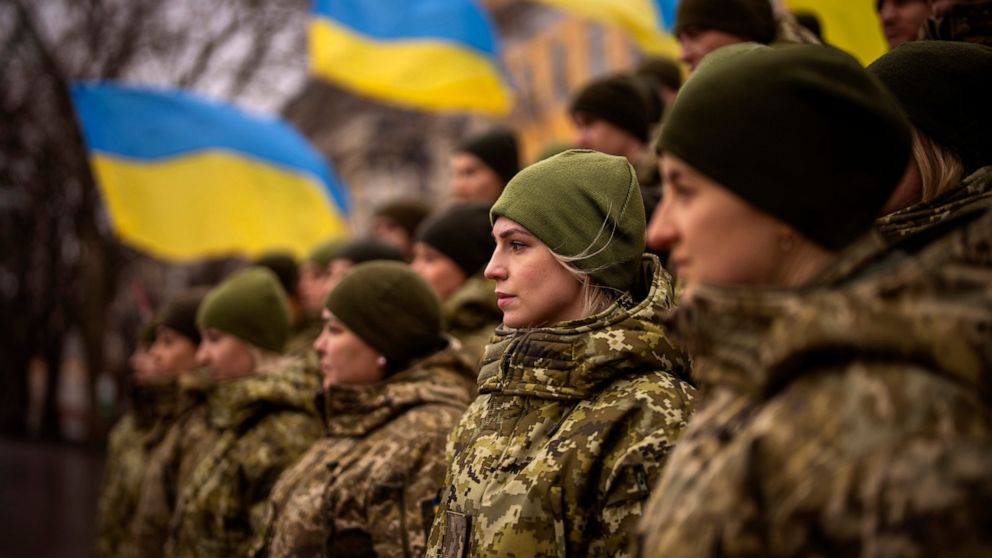 Ukrainian Army soldiers pose for a photo as they gather to celebrate a Day of Unity in Odessa, Ukraine, Wednesday, Feb. 16, 2022. As Western officials warned a Russian invasion could happen as early as today, the Ukrainian President Zelenskyy called 