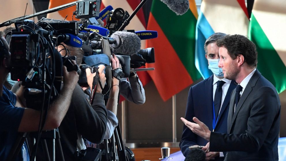 France's European Affairs Minister Clement Beune, right, speaks with the media as he arrives for a meeting of EU General Affairs ministers at the European Council building in Brussels, Tuesday, Sept. 21, 2021. European Union General Affairs ministers