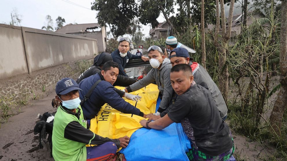 Indonesian rescuers and villagers evacuate a victim on a car in an area affected by the eruption of Mount Semeru in Lumajang, East Java, Indonesia, Sunday, Dec. 5, 2021. The highest volcano on Indonesia’s most densely populated island of Java spewed 