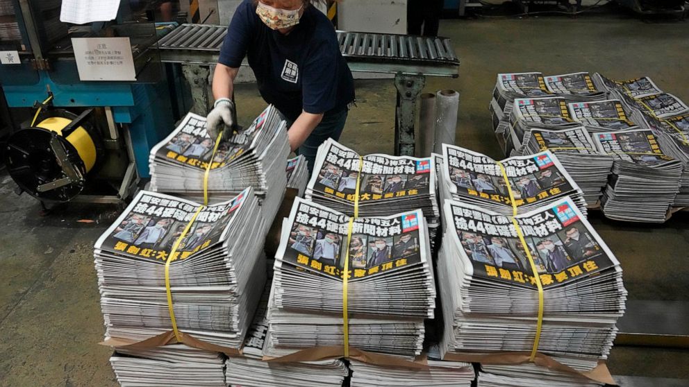 A worker packs copies of Apple Daily newspaper at the printing house in Hong Kong, early Friday, June 18, 2021. Five editors and executives at pro-democracy Apple Daily newspaper were arrested Thursday under Hong Kong's national security law, its sto