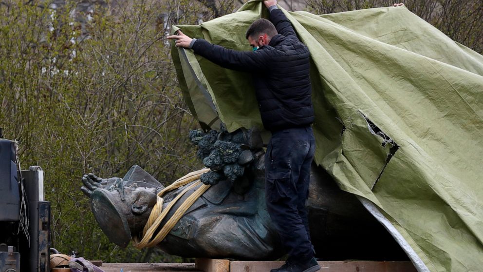 A worker covers the statue of a Soviet World War II commander Marshall Ivan Stepanovic Konev after its been removed from its site in Prague, Czech Republic, Friday, April 3, 2020. Marshall Konev led the Red Army forces that liberated Prague and large