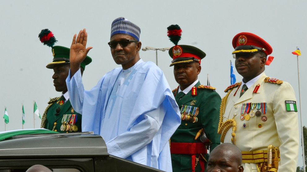 FILE - In this Monday, Oct. 1, 2018 file photo, Nigerian President Muhammadu Buhari waves to the crowd during the 58th anniversary celebrations of Nigerian independence, in Abuja, Nigeria. The United States and European Union are expressing concern a