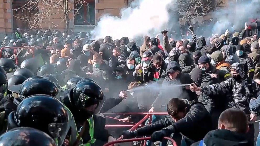 In this image from video provided by the Radio Free Europe/Radio Liberty, far-right demonstrators clash with riot police outside the presidential administration building in Kiev, Ukraine, Saturday, March 9, 2012. Three police officers in Ukraine have