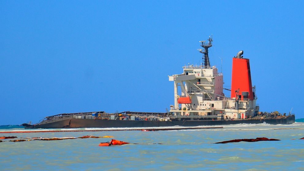 FILE — In this Sunday, Aug. 16 file photo the Japanese MV Wakashio, a bulk carrier ship that recently ran aground off the southeast coast of Mauritius, can be seen from the coast of Mauritius. The oil spill disaster turned deadly this week when a tug