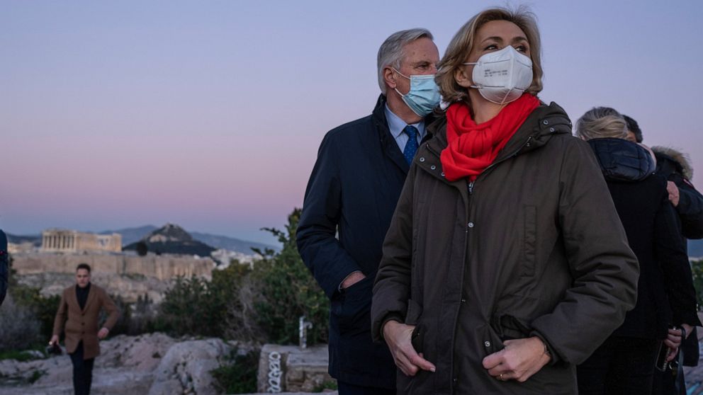 Conservative party Les Republicains candidate for the French presidential election 2022, Valerie Pecresse, right, stands at the Philopappos hills as at the ancient Parthenon temple is seen in background, during her visit to Athens, Friday, Jan. 14, 2