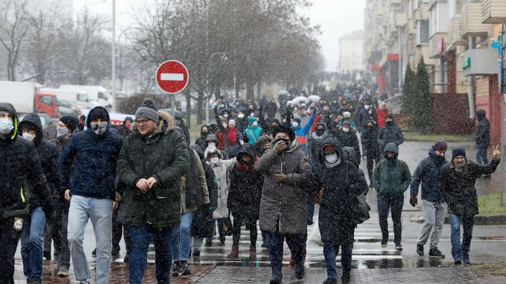 Demonstrators, some of them wearing face masks to help curb the spread of the coronavirus attend an opposition rally to protest the official presidential election results in Minsk, Belarus, Sunday, Nov. 29, 2020. A human rights group in Belarus says 