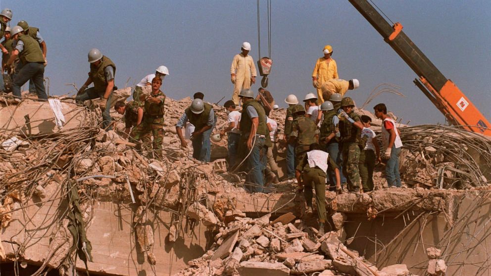 FILE - Rescue workers sift through the rubble of the U.S. Marine base in Beirut in Oct. 23, 1983 following a massive bomb blast that destroyed the base and killed 241 American servicemen. Iran told the United Nation’s highest court on Monday, Sept. 1