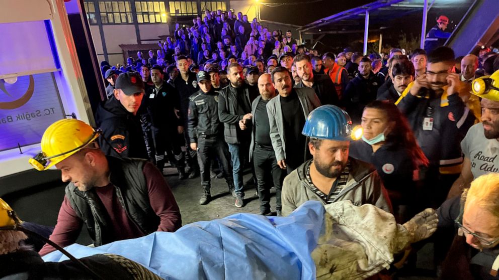 Miners carry the body of a victim in Amasra, in the Black Sea coastal province of Bartin, Turkey, Friday, Oct. 14, 2022. An official says an explosion inside a coal mine in northern Turkey has trapped dozens of miners. At least 14 have come out alive