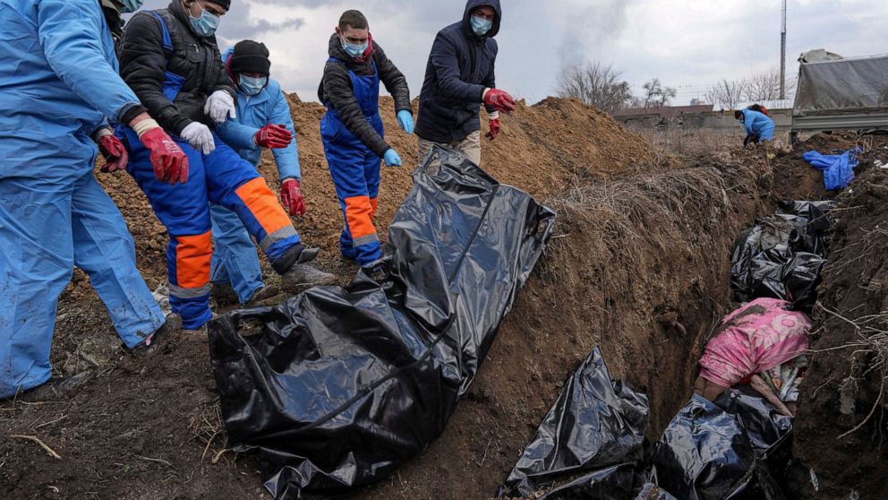 Besieged Ukraine city of Mariupol buries dead in mass grave