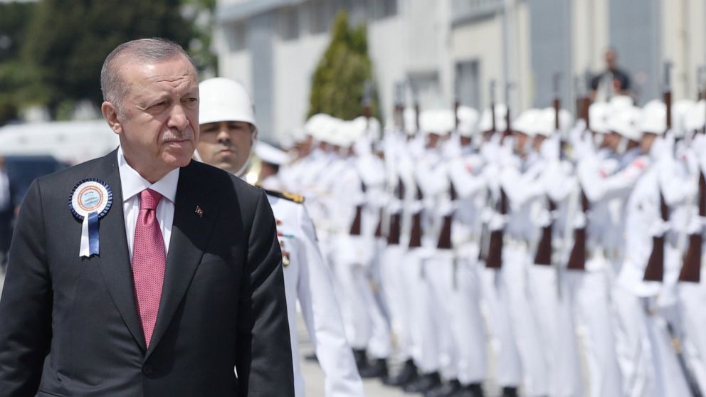 Turkish President Recep Tayyip Erdogan inspects a military honour guard during a ceremony marking the docking of a submarine, in Kocaeli, Turkey, Monday, May 23, 2022. Erdogan, whose country has objected to Sweden and Finland joining NATO, called on 