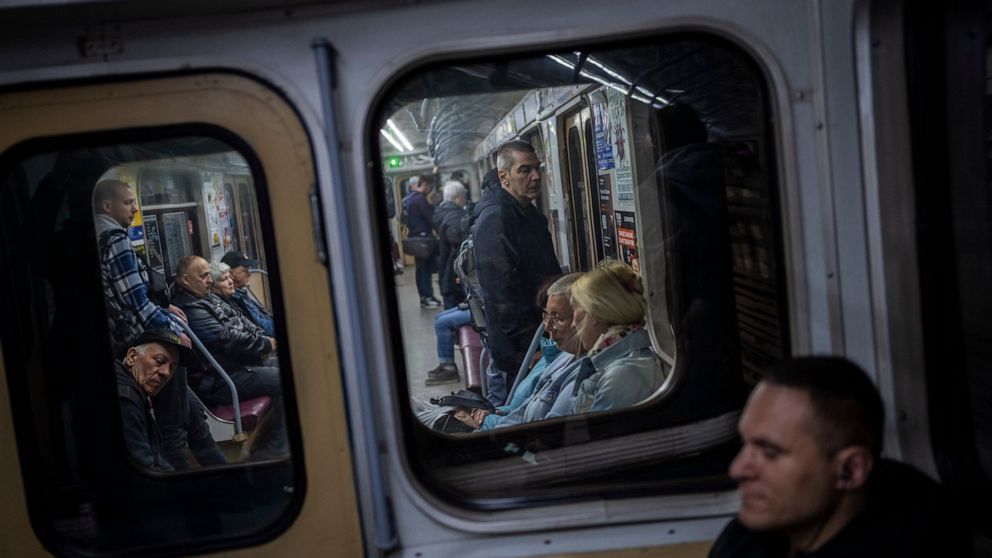 Commuters take the subway in Kharkiv, eastern Ukraine, Tuesday, May 24, 2022. Kharkiv subway resumed service on Tuesday morning after it was closed for more than two months during Russian attempt to capture the city. (AP Photo/Bernat Armangue)