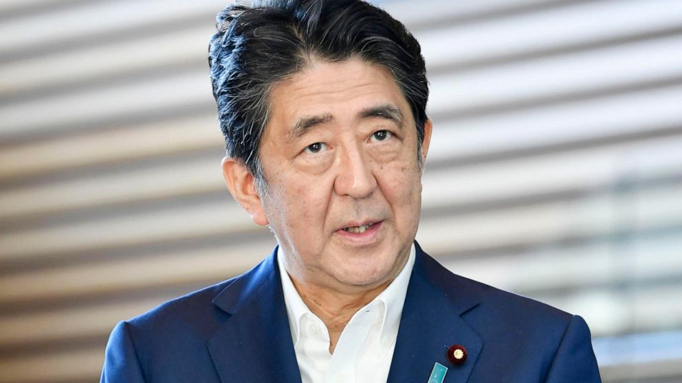 Japanese Prime Minister Shinzo Abe answers journalists'n questions at his official residence after returning from a hospital for a checkup, in Tokyo Wednesday, Aug. 19, 2020. Abe brushed off lingering worries about his health Wednesday, saying he wen
