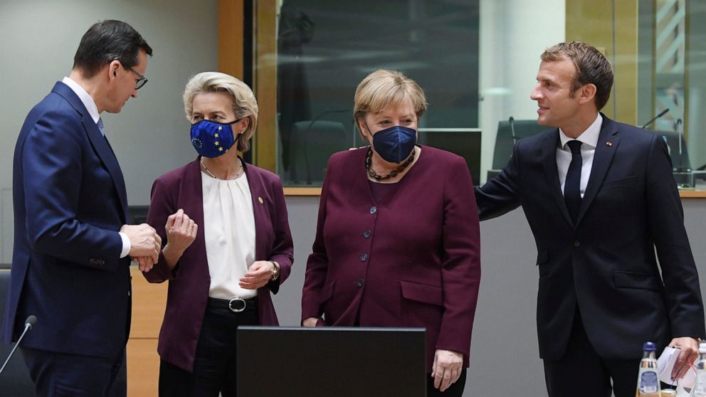 France's President Emmanuel Macron, right, talks to Germany's Chancellor Angela Merkel, second right, as Poland's Prime Minister Mateusz Morawiecki, left, speaks with European Commission President Ursula von der Leyen during a round table meeting at 