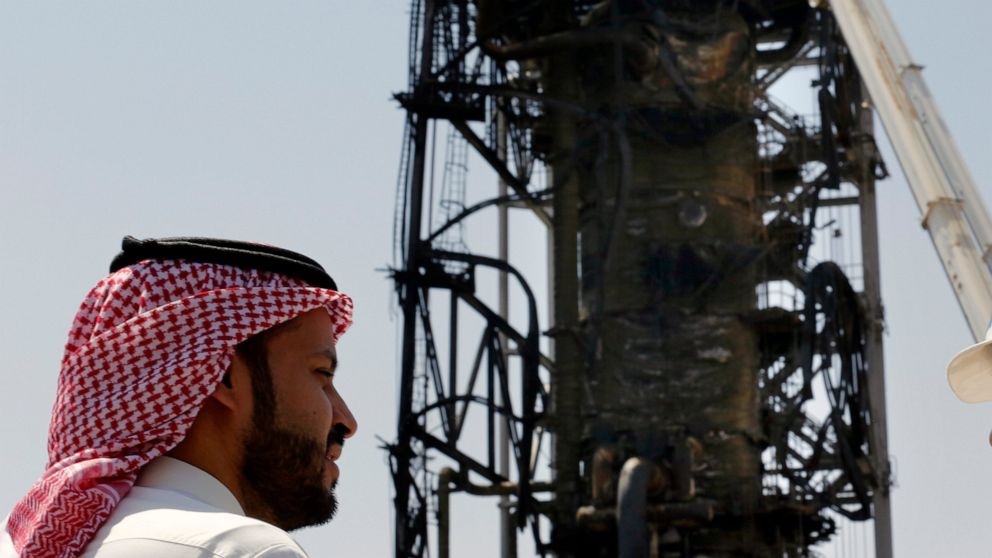 In this photo opportunity during a trip organized by Saudi information ministry, a man watches the damaged in the Aramco's Khurais oil field, Saudi Arabia, Friday, Sept. 20, 2019, after it was hit during Sept. 14 attack. Saudi officials brought journ