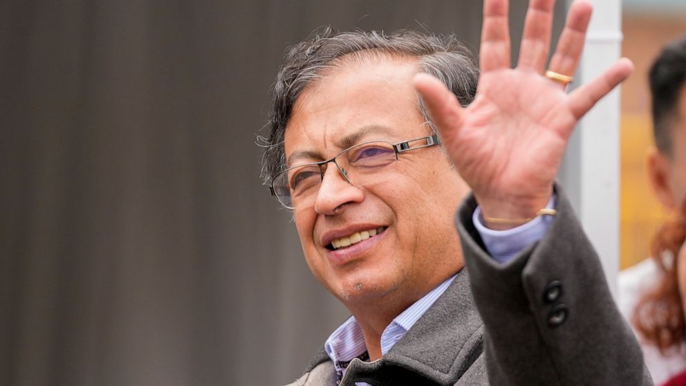 Gustavo Petro, presidential candidate with the Historical Pact coalition, waves upon his arrival to vote in a presidential runoff in Bogota, Colombia, Sunday, June 19, 2022. (AP Photo/Fernando Vergara)