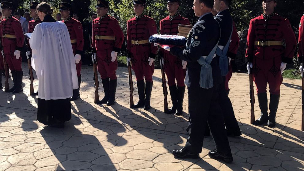 RAF officers hold a wreath and the remains of a WWII air gunner during a complete burial ceremony organized by the British Embassy at the Tirana Park Memorial Cemetery, in Tirana, Wednesday, Oct. 20, 2021. Sergeant Peter Twiddy on Wednesday will be l