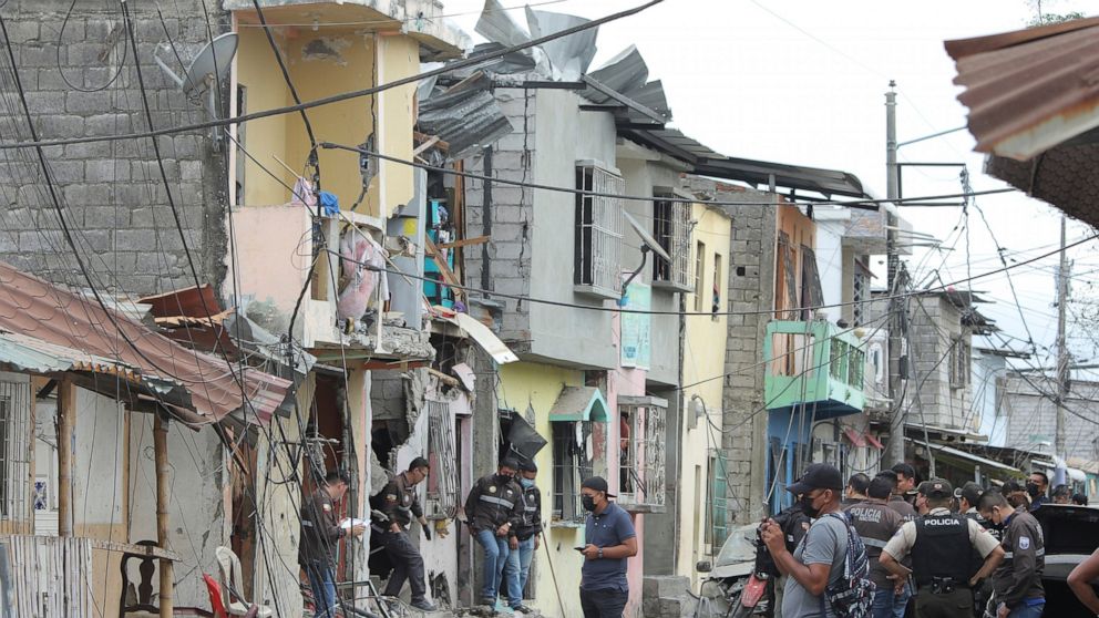 Police investigate the site of an explosion in the Cristo de El Consuelo neighborhood, in Guayaquil, Ecuador, Sunday, Aug. 14, 2022. According to the authorities a gunshot attack and subsequent explosion left at least five dead, 15 injured and severa