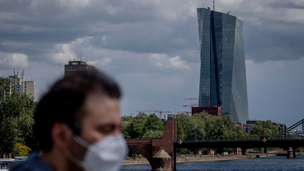 A man walks in front of the European Central Bank in Frankfurt, Germany, Wednesday, April 29, 2020. The ECB will have the meeting of the governing council on Thursday. (AP Photo/Michael Probst)