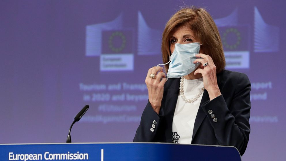 European Commissioner for Health Stella Kyriakides removes a mouth mask after addressing a media conference regarding tourism at EU headquarters in Brussels, Wednesday, May 13, 2020. The European Union unveiled Wednesday its plan to help citizens acr