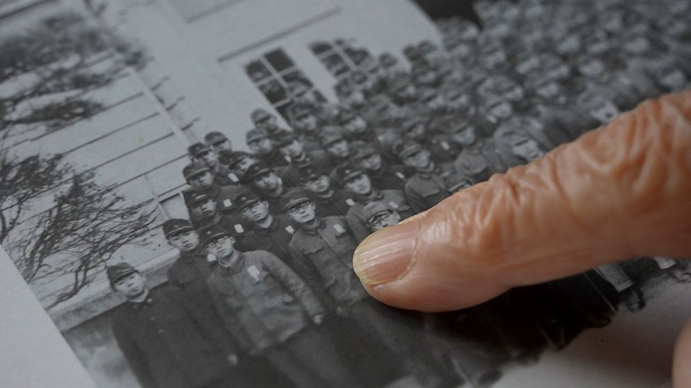 Shigeru Imaizumi, a 96-year old graduate from Kenkoku University, points to himself in a school photo, Sept. 16, 2022, in Toyokawa, Aichi prefecture, Japan. Kenkoku University was established in northern China in 1938 as a grand piece of imperial pro