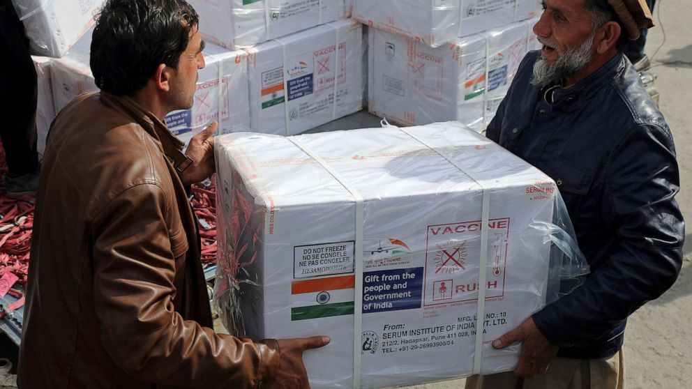 FILE- Afghan health ministry workers unloads boxes of the first shipment of 500,000 doses of the AstraZeneca coronavirus vaccine made by Serum Institute of India, donated by the Indian government, at the customs area of the Hamid Karzai International