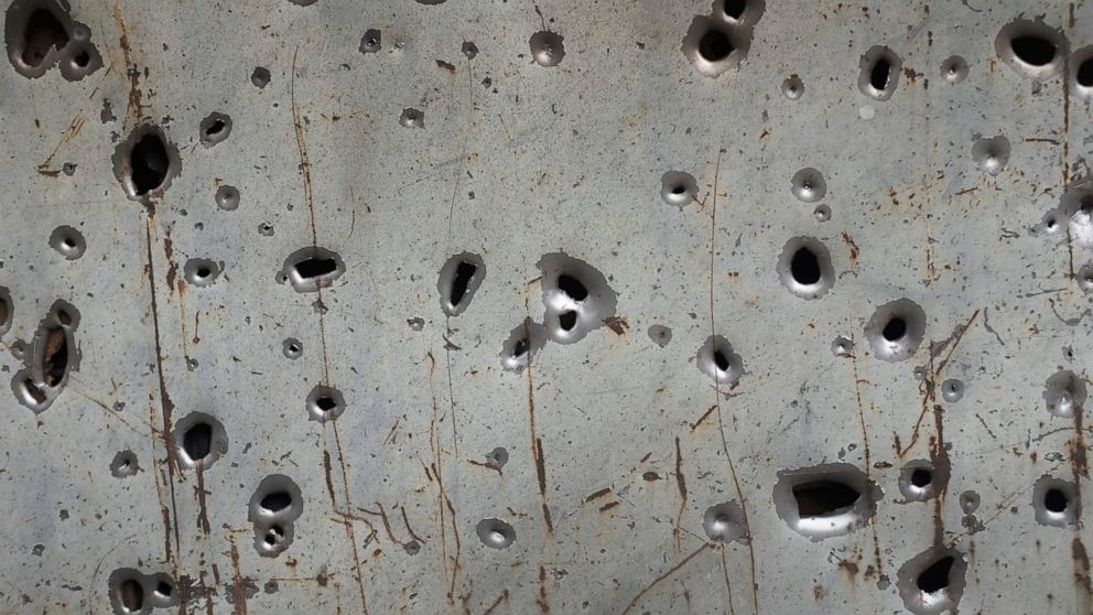 Shrapnel holes are seen in a fence in Hadrut province of self-proclaimed Republic of Nagorno-Karabakh, Azerbaijan, Thursday, Oct. 1, 2020. Two French and two Armenian journalists have been injured in the South Caucasus separatist region of Nagorno-Ka