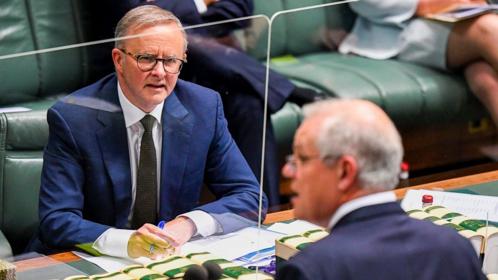 Australian Opposition Leader Anthony Albanese, left, watches as Prime Minister, Scott Morrison speaks during House of Representatives Question Time at Parliament House in Canberra, Thursday, Dec. 2, 2021. Australia's opposition leader says the nation
