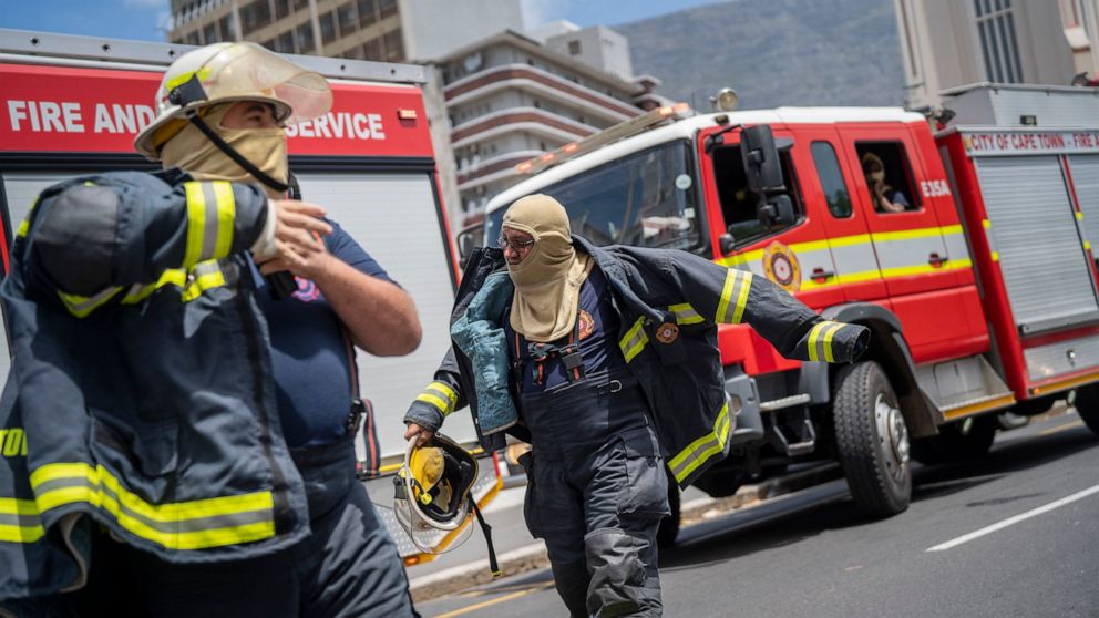 Reinforcement fire fighters arrive at South Africa's Parliament in Cape Town Sunday Jan 2, 2022 after it was engulfed in flames. (AP Photo/Jerome Delay)