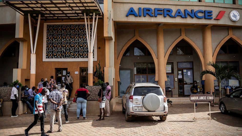 People queue at the office of French airline Air France in Ouagadougou Wednesday Jan. 26, 2022. Experts say that in the wake of Burkina Faso’s coup d’etat, instability could lead to ramped up jihadist attacks as tensions between the gendarme and mili