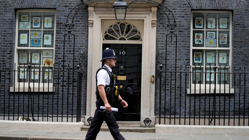 A police officer walks past 10 Downing Street in London, Monday, May 23, 2022. The general public waits for the release of Sue Gray's report into COVID lockdown breaches across Whitehall, the so called "Partygate". (AP Photo/Frank Augstein)