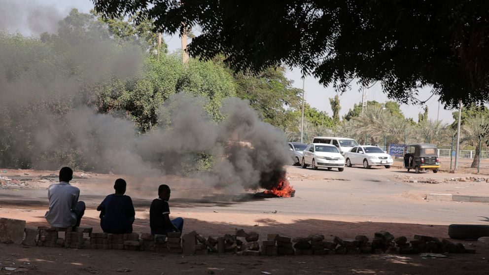 People burn tires in Khartoum, Sudan, Sunday, Nov. 7, 2021. Sudan's protest movement has rejected internationally backed initiatives to return to a power-sharing arrangement with the military after last month's coup, (AP Photo/Marwan Ali)