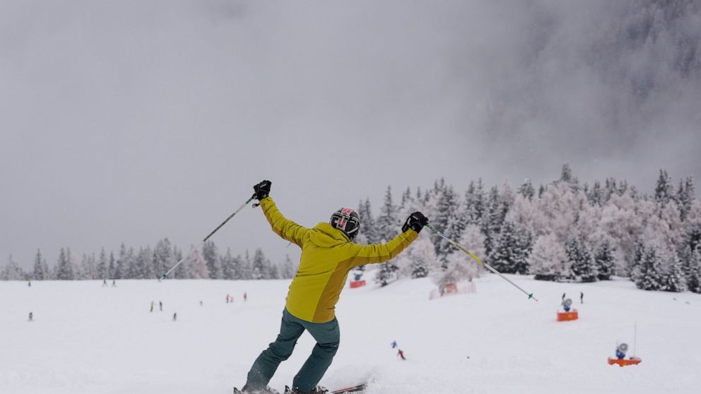 A tourist gestures while skiing, at Plan de Corones ski area, Italy South Tyrol, Saturday, Nov. 27, 2021. After nearly two years of being restricted to watching snow accumulate on distant mountains, Italian skiers are finally returning to the slopes 