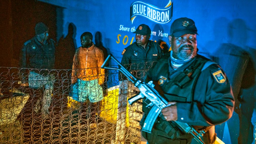Police patrol an area in Soweto, South Africa Tuesday, July 12, 2022 in search of illegal firearms following the weekend shooting in a bar which claimed 16 people. South African police are searching for illegally-held guns in patrols of Johannesburg'
