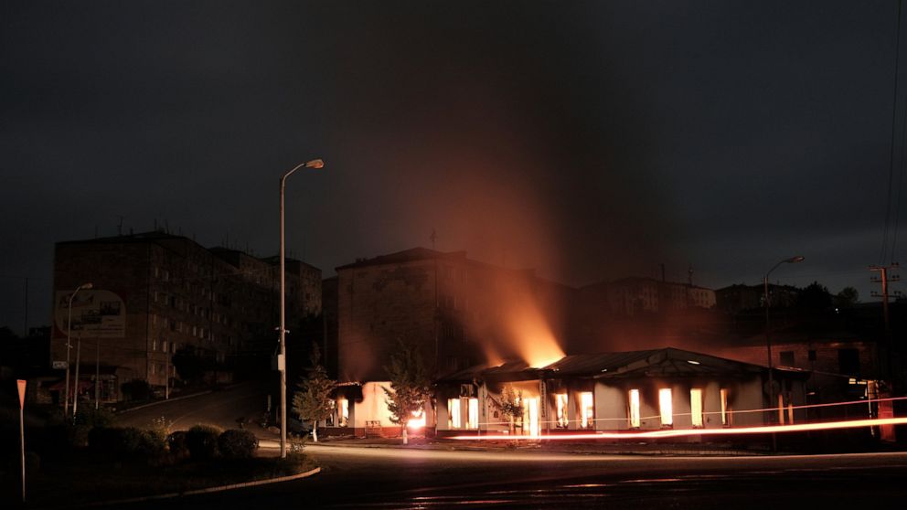 A building of a residential area burns after night shelling by Azerbaijan's artillery during a military conflict in self-proclaimed Republic of Nagorno-Karabakh, Stepanakert, Azerbaijan, early Sunday, Oct. 4, 2020. Armenian officials on Sunday accuse