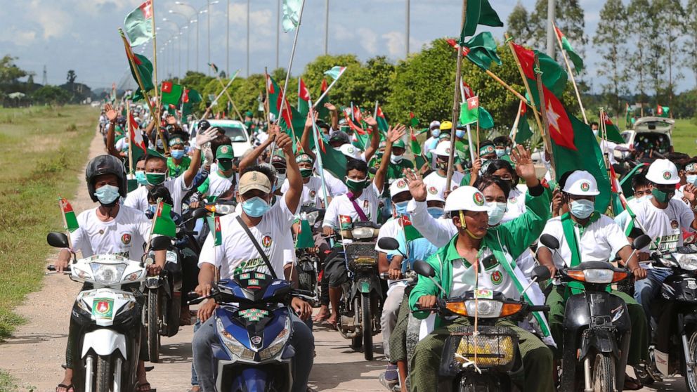 Supporters of the. military-backed Union Solidarity and Development Party (USDP) wave the party flags and cheer from their motorbikes during an election campaign for next month's general election, Thursday, Oct. 1, 2020, in Naypyitaw, Myanmar. (AP Ph