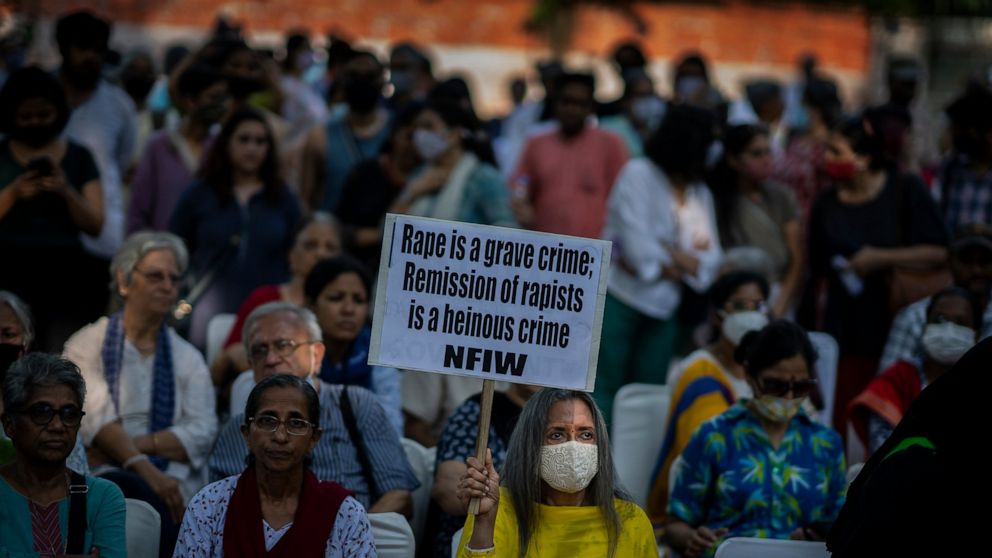 A woman holds a placard during a protest against remission of sentence by the government to convicts of a gang rape of a Muslim woman, in New Delhi, India, Saturday, Aug. 27, 2022. The victim, who is now in her 40s, was pregnant when she was brutally