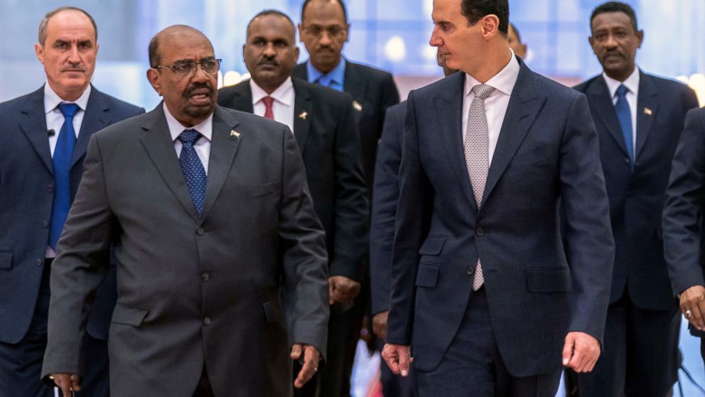 FILE - In this file photo released by the Syrian official news agency SANA Dec. 16, 2018, Syrian President Bashar Assad, right, meets with Sudan's President Omar Bashir in Damascus, Syria. Assad has survived years of war and millions of dollars in mo