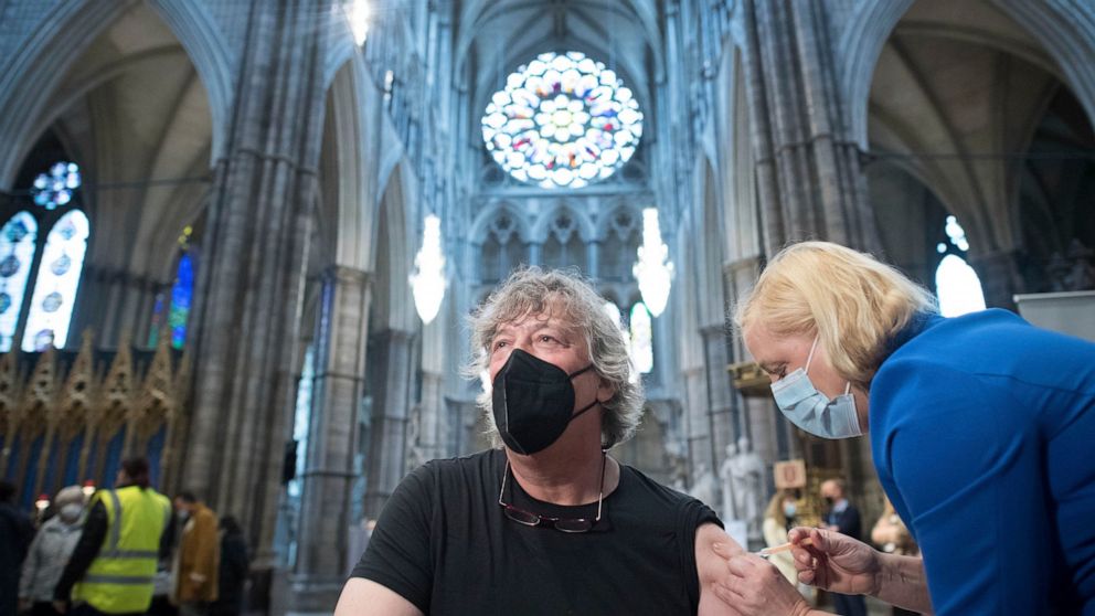 Actor Stephen Fry receives a COVID-19 jab, at a new vaccination site, at Poets' Corner in Westminster Abbey, London, Wednesday March 10, 2021. (Stefan Rousseau/PA via AP)